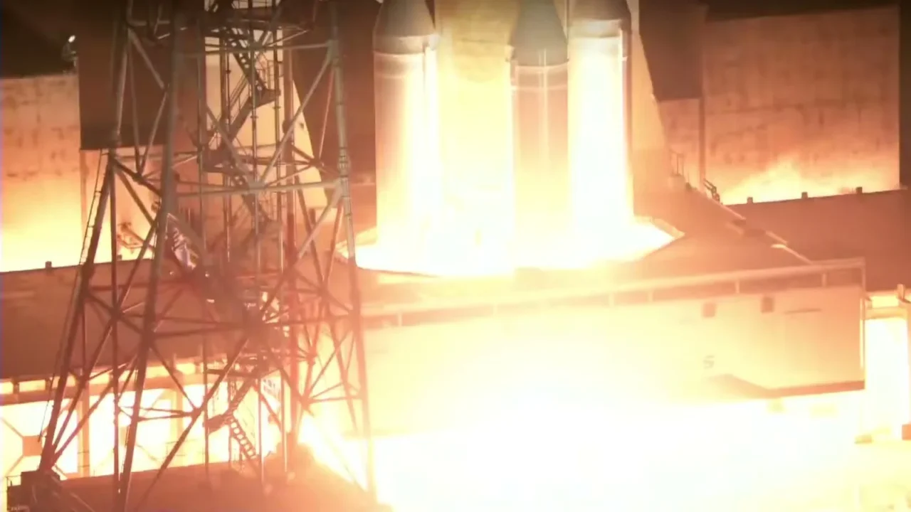 Motores do foguete H3 acendem na plataforma do Centro Espacial de Tanegashima e iluminam de laranja a torre e a base de lançamento