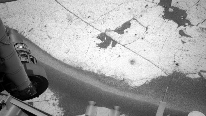 Imagem do furo de perfuração “Basque Lakes” e dos resíduos ao redor (o pequeno monte perto do canto inferior direito da rocha de base da área de trabalho). O rover Curiosity, da NASA, para Marte, obteve esta imagem usando sua Câmera de Navegação Esquerda (Navcam) em 24 de setembro de 2026, Sol