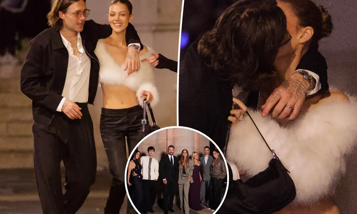 Casal compartilha beijo e momentos durante noite em Paris, enquanto grupo de pessoas posa para foto em local fechado