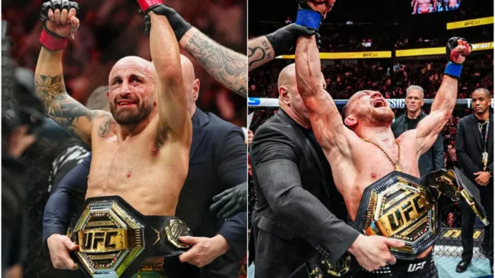 Dois lutadores de MMA, um de cabelo raspado e barba, outro de cabelo escuro e cordão no pescoço, erguem os braços e seguram cinturões dourados do UFC dentro do octógono