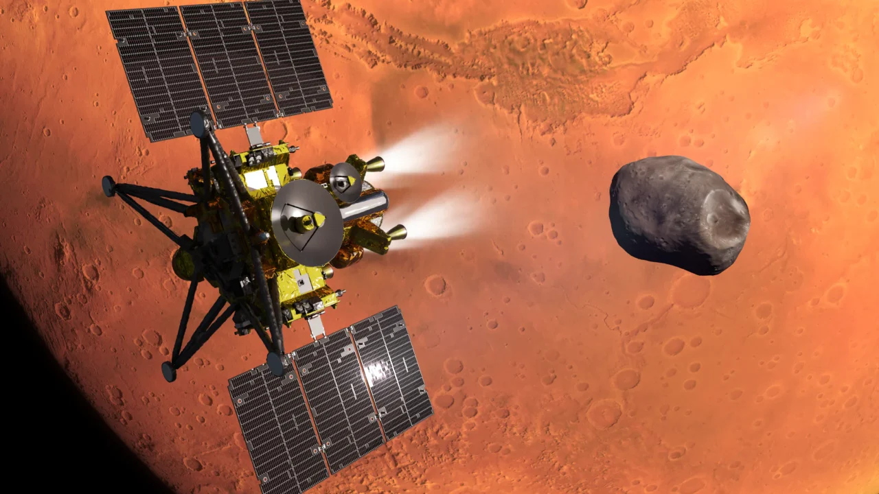 Concepção artística da nave MMX da JAXA durante a inserção na órbita de Marte. A lua marciana Fobos, que a MMX irá explorar e coletar amostras, aparece ao fundo.