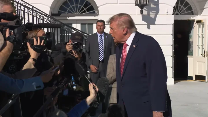 Donald Trump responde a jornalistas cercado de câmeras e microfones na saída da Casa Branca, em 19 de outubro de 2026