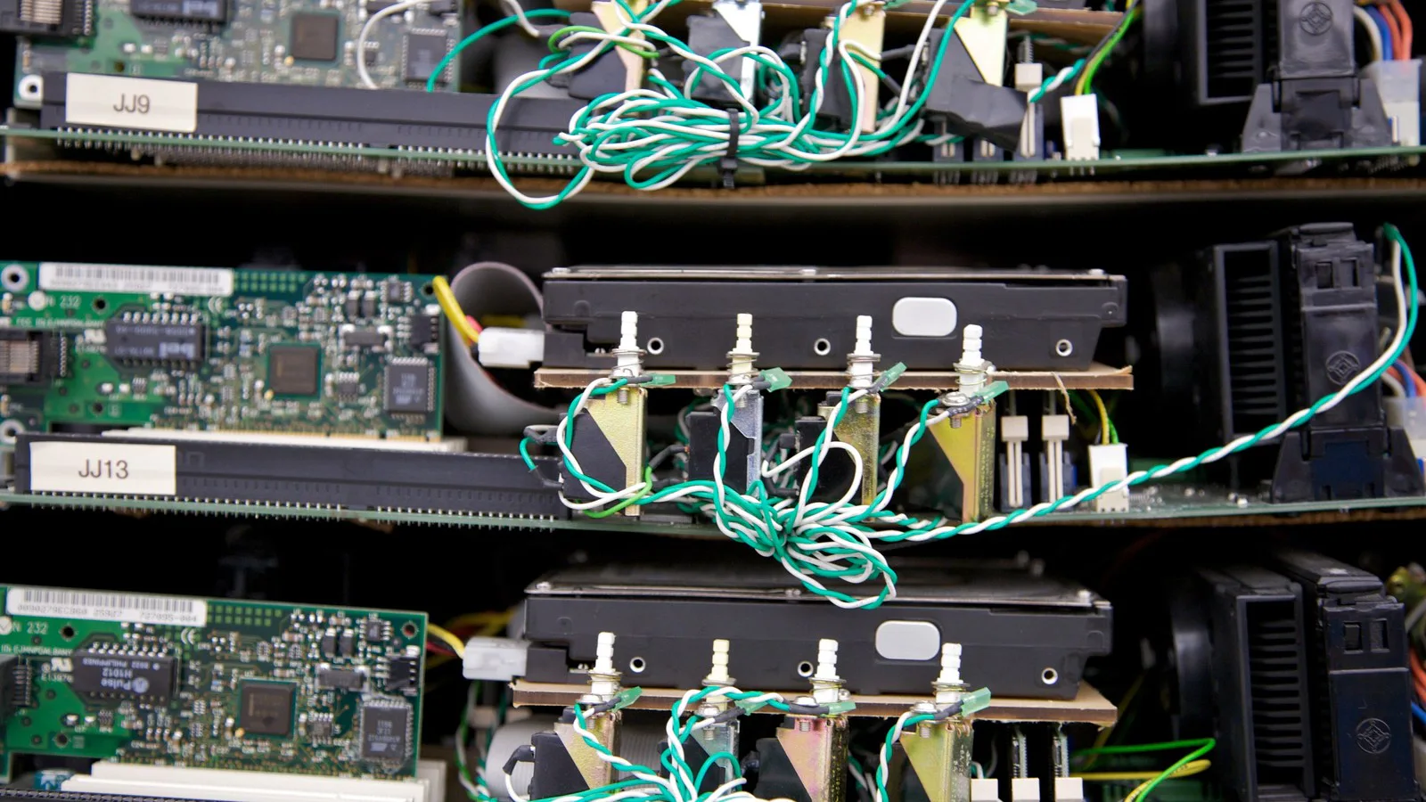 Placas de computador, discos rígidos e fios montados em prateleiras no servidor "corkboard" usado pelo Google por volta de 1999, em exposição no Computer History Museum, na Califórnia
