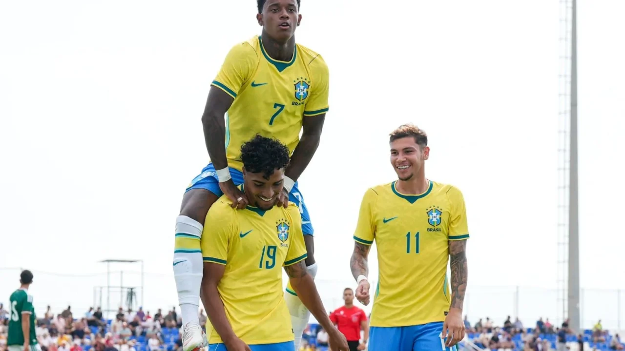 Jogadores da seleção brasileira sub-20 comemoram gol durante partida contra o México em estádio com torcida ao fundo